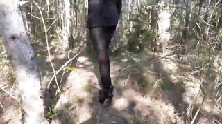 Walking on the wood wearing a black dress pantyhose heels