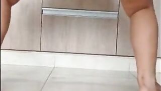 dancing and booty shaking in the kitchen  in tight shorts