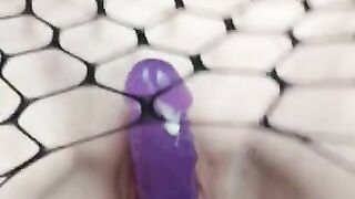 Beautiful pussy in fishnet pantyhose fucks dildo