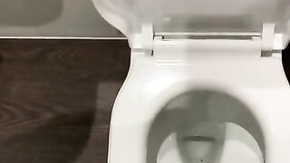 Wanking off in public cubicle with big cumshot at the end