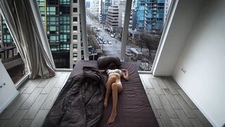 A fragile girl lays by the window and masturbates her holes in Vancouver center