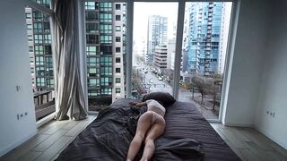 A fragile girl lays by the window and masturbates her holes in Vancouver center